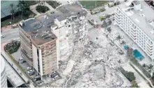  ?? AMY BETH BENNETT/ SOUTH FLORIDA SUN SENTINEL ?? Part of the 12-story oceanfront Champlain Towers South Condo in Surfside, with more than
100 units, that collapsed June 24.