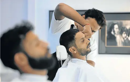  ?? Picture: AFP ?? Customers sit back and relax at a men’s salon in Islamabad where grooming includes skin treatments and manicures. Social media has played a major role in the trend among men in Pakistan to try to look their best.