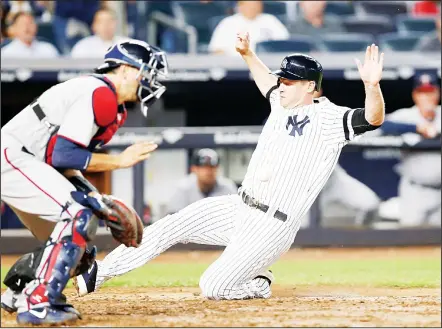  ??  ?? Minnesota Twins catcher Jason Castro waits for the throw as New York Yankees designated hitter Chase Headley scores on Todd Frazier’s sixth-inningsacr­ifice fly in a baseball game in New York on Sept 18.