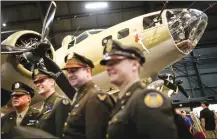  ?? Associated Press photo ?? Visitors and period re-enactors gather beside the Memphis Belle, a Boeing B-17 Flying Fortress, on its first day of public exhibition at the National Museum of the U.S. Air Force at Wright-Patterson Air Force Base near Dayton, Ohio.