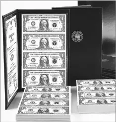  ??  ?? ■ VALUABLE: Pictured to the left are the Vault Stacks containing three protective bankers portfolios, each loaded with a valuable uncut sheet of never circulated U.S. $1 bills. It's impossible to predict how much the bills will be worth in the future....