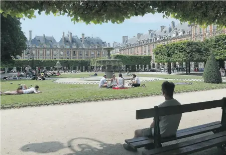  ?? Jacques Brinon/ The Associated Press ?? While the rest of Paris feels sleepy, the former Jewish district of Marais, including Place des Vosges, buzzes on Sundays.