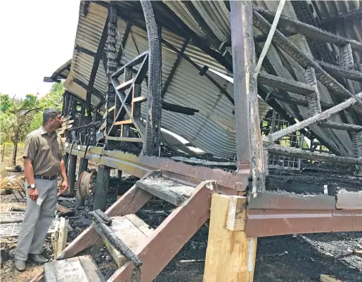  ?? Photo: Ashna Kumar ?? Arun Prasad looks at his house after it was destroyed in a fire on January 24, 2018.