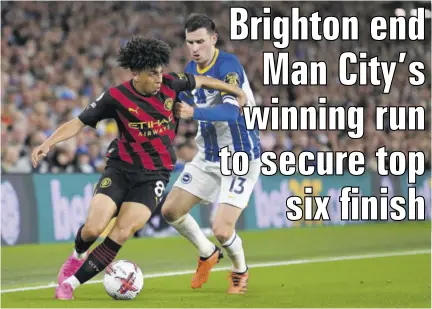  ?? (Photo: AFP) ?? Manchester City defender Rico Lewis (left) fights for the ball with Brighton midfielder Pascal Gross during their English Premier League football match at the American Express Community Stadium in Brighton, England, on Wednesday.