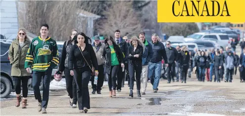  ?? LIAM RICHARDS / THE CANADIAN PRESS ?? Mourners head into a memorial service for Logan Schatz, captain of the Humboldt Broncos hockey team, in Allan.