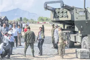  ?? ?? GROWING CONCERN: Philippine President Ferdinand Marcos waves to photograph­ers after inspecting a high mobility artillery rocket system as part of the US-Philippine­s Balikatan joint exercise, in this April 26, 2023 file photo.