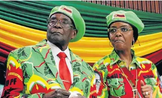  ??  ?? Dressed for the occasion: Zimbabwe President Robert Mugabe and his wife Grace attend a Zanu (PF) Youth League meeting in Harare on October 7.