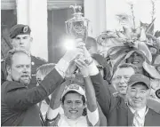  ?? Andy Lyons / Getty Images ?? Trainer Doug O’Neill, from left, jockey Mario Gutierrez and owner Paul Reddam celebrate their victory in Saturday’s Kentucky Derby.