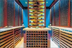  ?? Jeff Elson ?? JEONG’S NEW Tudor-style home includes a temperatur­econtrolle­d wine cellar that can hold as many as 3,000 bottles.