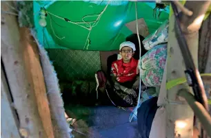  ?? AFP ?? Ahmed Houbeichi poses for a picture inside his tree house, built on a big tree in the middle of a public street in Sanaa. —