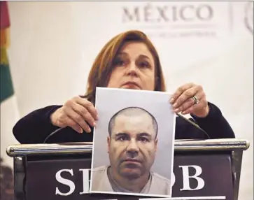  ?? Yuri Cortez
AFP/ Getty I mages ?? ATTY. GEN. ARELY GOMEZ of Mexico holds a picture of Joaquin “El Chapo” Guzman. She said her off ice was analyzing the U. S. extraditio­n request when Guzman escaped. Mexico had denied receiving such a request.