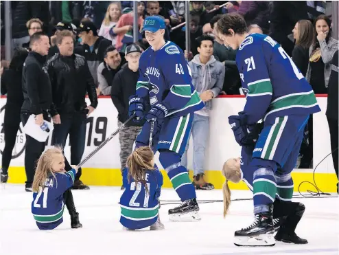  ?? RICHARD LAM/PNG FILES ?? Pettersson has a little fun pulling sisters Blanca and Elle Eriksson around the ice while the girls’ dad, Loui Eriksson, entertains another daughter, Lola, after the Canucks’ Super Skills Contest earlier this month.