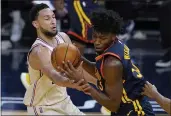  ?? JEFF CHIU — THE ASSOCIATED PRESS ?? Warriors center James Wiseman, right, is defended by 76ers guard Ben Simmons during the second half on Tuesday in San Francisco.