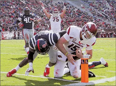  ?? Arkansas Democrat-Gazette/BENJAMIN KRAIN ?? Arkansas quarterbac­k Cole Kelley dives into the end zone for a touchdown late in the second quarter of the Razorbacks’ 38-37 victory over Mississipp­i on Saturday at Vaught-Hemingway Stadium in Oxford, Miss.