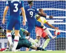  ??  ?? Handing it away: Fernandinh­o handles the ball to give Chelsea their winning penalty