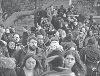  ?? ASSOCIATED PRESS ?? Brooklyn College students walk between classes on campus in New York. When the student loan bills come due, walking away can be disastrous for your financial future.