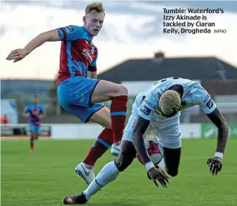  ?? INPHO ?? Tumble: Waterford’s Izzy Akinade is tackled by Ciaran Kelly, Drogheda