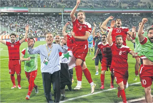  ?? AP ?? Syria players celebrate their 2-2 draw with Iran in a World Cup qualifying match in Tehran last month.