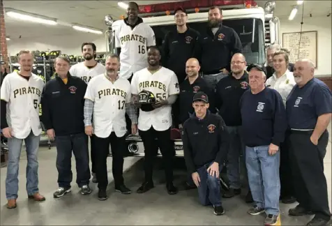 ?? Jason Mackey/Post-Gazette ?? GIVING BACK Josh Bell, center, along with manager Derek Shelton, first base coach Tarrik Brock, Clay Holmes and Sam Howard visited with the members of the McDonald Volunteer Fire Department Thursday morning as part of a week of visits and events leading up to PirateFest Saturday.
