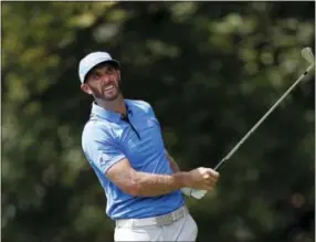  ?? JOHN BAZEMORE — THE ASSOCIATED PRESS ?? Dustin Johnson watches his tee shot on the second hole during the second round at the Tour Championsh­ip at East Lake Golf Club in Atlanta on Friday.