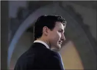  ?? CP PHOTO ADRIAN WYLD ?? Prime Minister Justin Trudeau listens to a question from the media in the foyer of the House of Commons following the release of an ethics report in Ottawa on Wednesday.