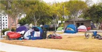  ?? NELVIN C. CEPEDA U-T FILE ?? Tents set up at Harborside Park in Chula Vista in August. At one time an estimated four dozen people lived there. The city ultimately closed off the park for all uses.