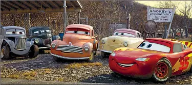  ??  ?? River Scott (Isiah Whitlock Jr.), Junior Moon (Junior Johnson), Smokey (Chris Cooper), Louise Nash (Margo Martindale) and Lightning McQueen (Owen Wilson) demonstrat­e they’re not quite ready for the junk pile in Cars 3.