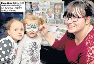  ??  ?? Face time Bridgett (7) and Belle Scotland (4) get their faces painted by Jade Watters