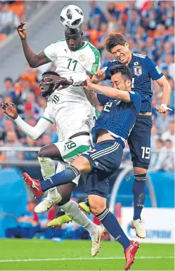  ?? Picture: Getty Images. ?? Senegal’s Cheikh Ndoye and Mbaye Niang in a mid-air battle with Yuya Osako and Maya Yoshida of Japan.