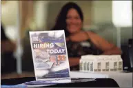  ?? Marcio Jose Sanchez / Associated Press ?? A hiring sign is placed at a booth for prospectiv­e employers during a job fair Wednesday in Los Angeles.