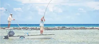  ??  ?? An angler at work at the front of a flats skiff. Bonefish are plentiful and were the initial attraction.