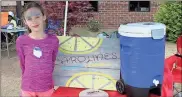  ??  ?? LEFT: Nine-year-old Caroline Looney has her lemonade stand set up at the South Rome Spring Festival.