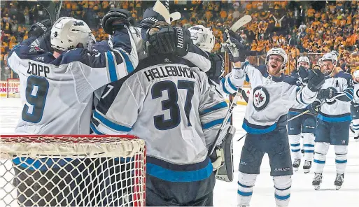  ?? FREDERICK BREEDON/GETTY IMAGES ?? The Winnipeg Jets, with 36 saves from Vezina Trophy finalist Connor Hellebuyck, celebrated after cruising to victory on the road and punching their ticket to the Western Conference final — the first trip to the NHL’s final four in franchise history.