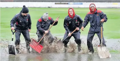  ??  ?? JANUARY: Lancashire CCC players had a splashing time helping to repair Ramsbottom Cricket Club ground after it flooded