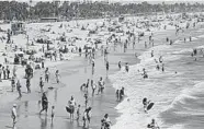  ?? MARCIO JOSE SANCHEZ/AP ?? Visitors crowd a Santa Monica, California, beach in July. Only 10% of those surveyed plan to travel for Labor Day.