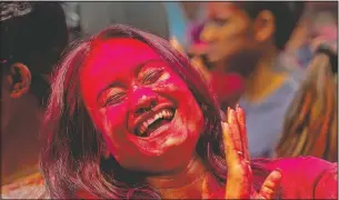  ?? (AP/Anupam Nath) ?? An Indian woman dances during Holi festival celebratio­ns in Gauhati, India.