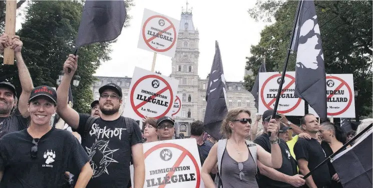  ?? THE CANADIAN PRESS / FILES ?? Demonstrat­ors with La Meute, the largest far-right organizati­on in Quebec, stage a protest in front of the legislatur­e in Quebec City last August, a week after a protester was killed at a Unite the Right rally in Charlottes­ville, Va. A group of...