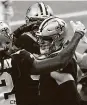  ?? Chris Graythen / Getty Images ?? Saints QB Taysom Hill, right, celebrates his 9-yard TD run in the fourth quarter that forced overtime.