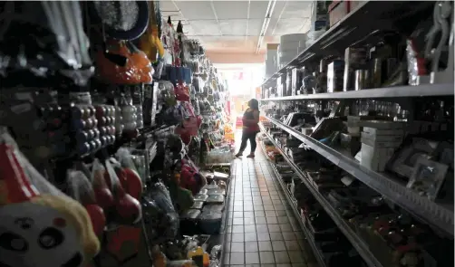  ??  ?? A SHOPPER looks for goods during an electricit­y load-shedding blackout, in Johannesbu­rg, yesterday.