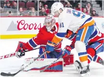  ??  ?? New York Islanders captain John Tavares shoots the puck past Montreal Canadiens goaltender Carey Price for the game-winner on Monday night.