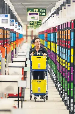  ?? Picture: Getty. ?? Staff at Amazon’s fulfilment centres were busy as people took advantage of the deals on offer.