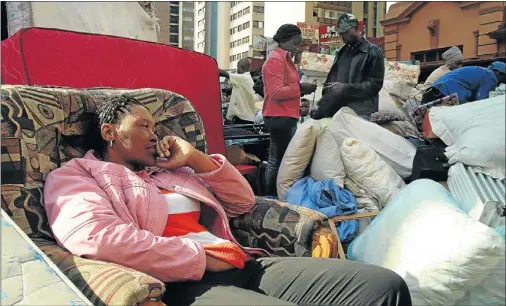  ?? PHOTO: MOSHE
SEKETE ?? DISTRAUT: A picture of utter despair is written in the face of a woman in the streets with her belongings after being evicted by the Red Ants, which are known for their forceful removal of people, in one of the images that form part of exhibition. The...