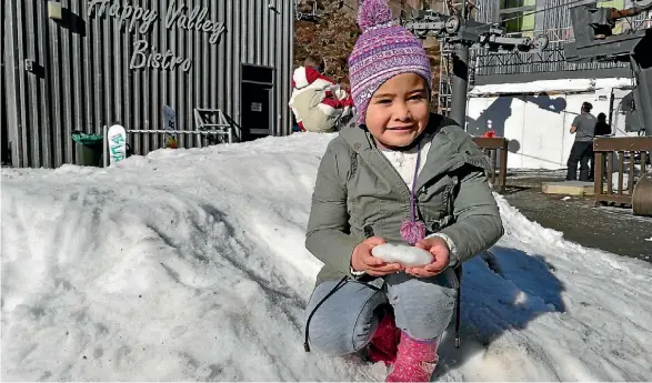  ?? FRANCES FERGUSON/FAIRFAX NZ ?? Khloe-Joy Tamihana has fun in the snow mound children can play in for free outside Happy Valley Bistro.