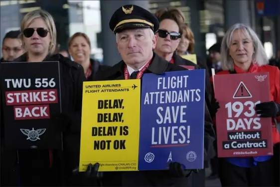  ?? NAM Y. HUH — THE ASSOCIATED PRESS ?? Flight attendants and a pilot protest at O’hare Internatio­nal Airport in Chicago on Tuesday. Three separate unions representi­ng flight attendants at major U.S. airlines are picketing and holding rallies at 30airports Tuesday as they push for new contracts and higher wages.