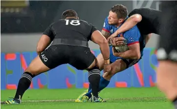  ??  ?? All Blacks Ofa Tu’ungafasi, left, and Sam Cane tackle France wing Remy Grosso.