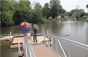  ?? TY WRIGHT/NEWARK ADVOCATE ?? Locals check out the new canoe and kayak launch on the dock at the Canoe/kayak Launch Park on the Perry County side of Buckeye Lake in Thorn Township on Wednesday. This is the only public access to launch a canoe or kayak on Buckeye Lake.