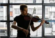  ?? ?? Victor Rojas, a Venezuelan violinist, arrived in 2018 on a visa that has allowed migrants access to Colombian bank accounts, health care and jobs. He says, however, he does not plan to make the country his permanent home.