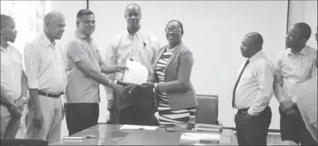  ??  ?? Minister of Education Dr Nicolette Henry (fifth from left) handing over the contract to CEO of BK Internatio­nal Inc, Brian Tiwarie on January 7th this year.