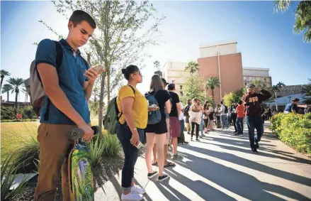  ?? ARIZONA REPUBLIC FILE DAVID WALLACE/THE ?? Arizona State University student Alex Riordan, left, a first-time voter, and others stood in line for up to 21⁄2 hours to vote on Nov. 6, 2018. As of Oct. 23, more than 5 million young people ages 18-29 had voted early or absentee in the 2020 elections, according to statistics compiled by the CIRCLE research center at Tufts University in Massachuse­tts.