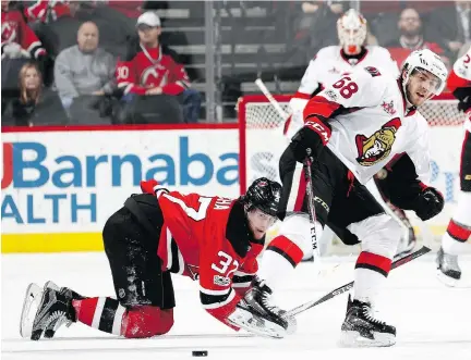  ?? ELSA/GETTY IMAGES ?? Senators forward Mike Hoffman, right, may not be available Tuesday to battle Pavel Zacha and the New Jersey Devils. Hoffman remains a question mark after leaving Sunday’s game against Winnipeg with an undisclose­d injury.